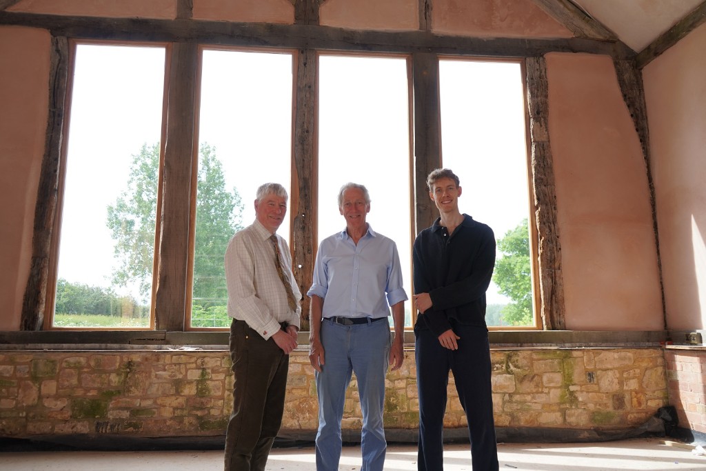Three people stood in front of a window